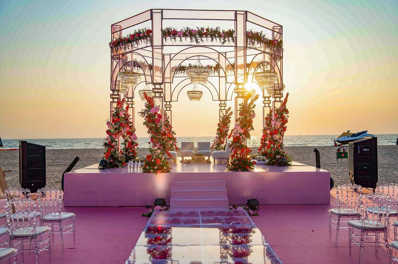 Wedding ceremony of a couple in an outdoor wedding setup with floral arch.